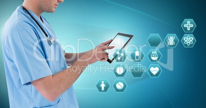 Male doctor holding tablet with medical interface hexagon icons