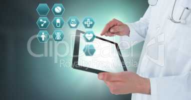 Doctor holding tablet with medical interface hexagon icons