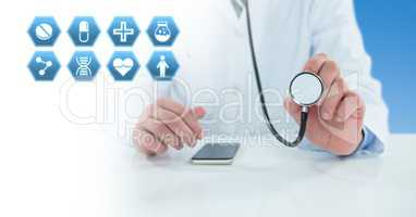 Male doctor holding stethoscope with medical interface hexagon icons