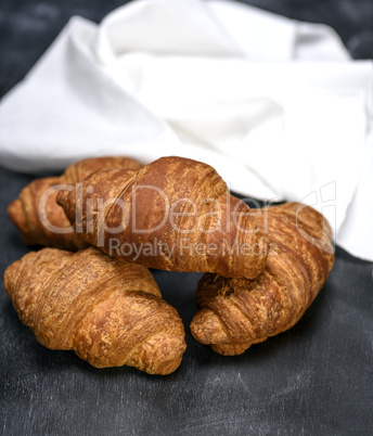 baked croissants on a black wooden table