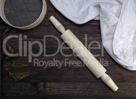 wooden rolling pin and a wooden round sieve