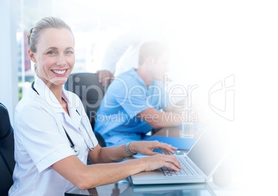 Female doctor working on laptop