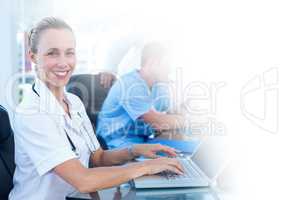 Female doctor working on laptop