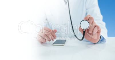 Male doctor holding stethoscope