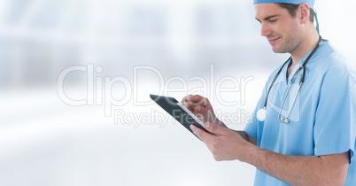 Male doctor holding tablet