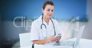 Female doctor using phone