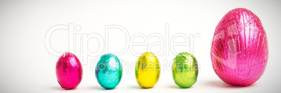 Four small easter eggs beside large one