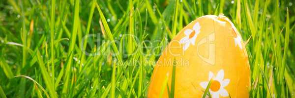 Orange easter egg in the grass