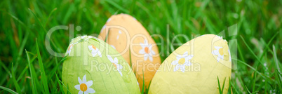 Three easter eggs in the grass