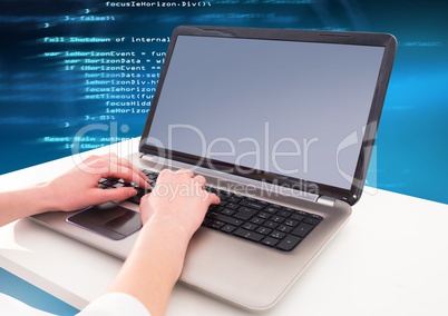 Hands typing coding text on laptop