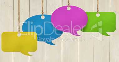 Hanging paper speech bubbles and wood background