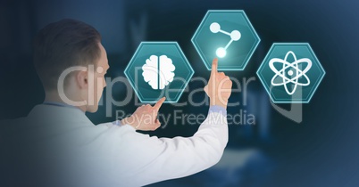Male doctor interacting with medical hexagon interface Male doctor interacting with medical hexagon interface