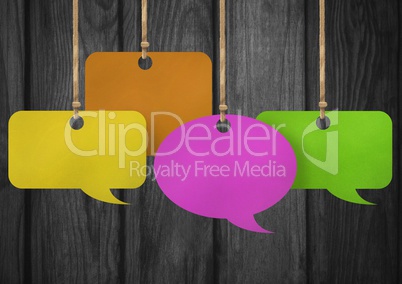 Hanging paper speech bubbles and wood background