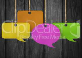 Hanging paper speech bubbles and wood background