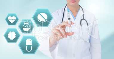 Doctor holding syringe with medicine drugs icons in hexagon interface