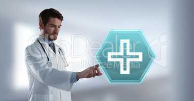 Male doctor interacting with medical cross icon hexagon interface