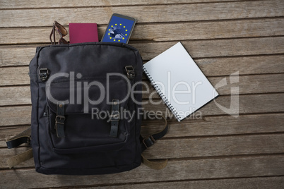 Composite image of vacation bag on wooden plank and accessories on wooden plank