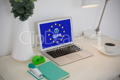 Composite image of laptop and office accessories on table