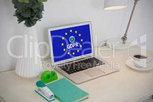 Composite image of laptop and office accessories on table