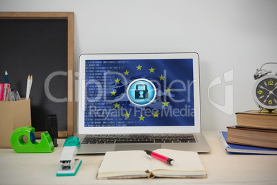 Composite image of laptop and various office accessories on table