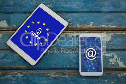 Composite image of mobile phone and digital tablet on wooden plank