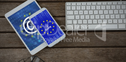 Composite image of digital tablet, mobile phone, pot plant and keyboard on wooden plank