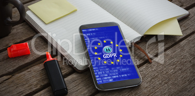 Composite image of organizer, coffee, mobile phone and stationery on wooden plank