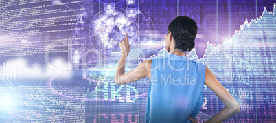 Composite image of rear view of businesswoman with hand on hip touching interface