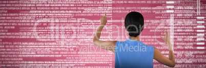 Composite image of rear view of businesswoman touching interface while holding something