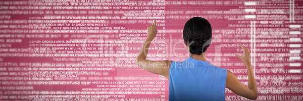 Composite image of rear view of businesswoman touching interface while holding something