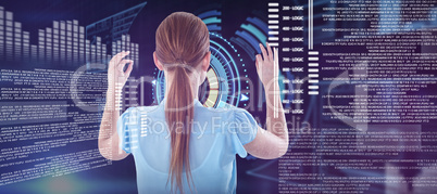 Composite image of rear view of businesswoman touching imaginary interface