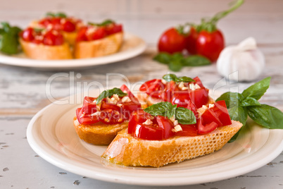 Italian bruschetta with tomato, basil and garlic on a plate