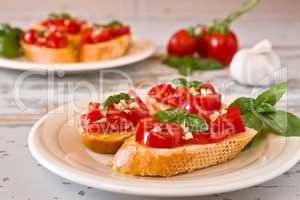 Italian bruschetta with tomato, basil and garlic on a plate