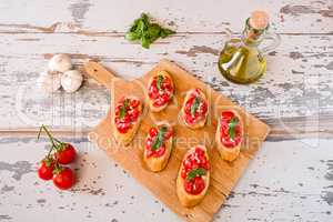 Italian bruschetta with tomato, basil and garlic seen from above