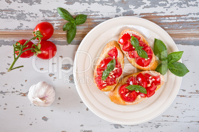 Italian bruschetta with tomato, basil and garlic on a plate