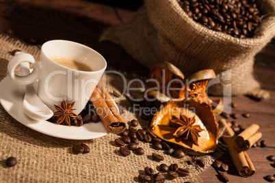Close-up of coffee cup with star anise and cinnamon