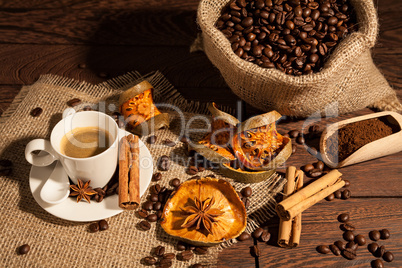 Coffee cup with cinnamon, star anise and dried orange fruit
