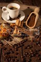 Cup of coffee with cinnamon and dried orange fruit
