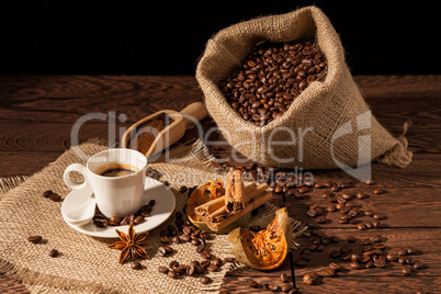 Coffee cup with cinnamon, star anise and dried orange fruit
