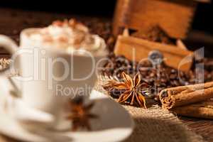 Close-up on star anise and cinnamon sticks with coffee cup