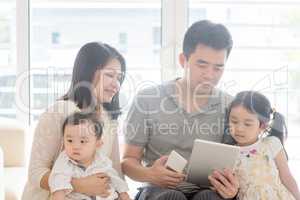 Asian family using tablet and smart phone