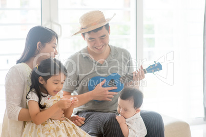 Asian family playing music instrument