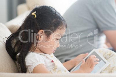 Little girl using digital tablet.