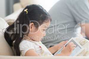 Little girl using digital tablet.