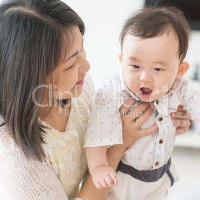 Mother playing with son.