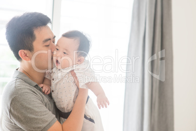 Father kissing baby son.