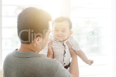 Father carrying baby son.