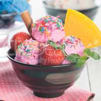 Pink ice cream with fruits bowl