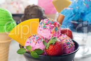 Pink ice cream with fruits in bowl