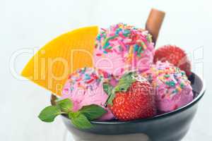 Pink ice cream with fruits close up